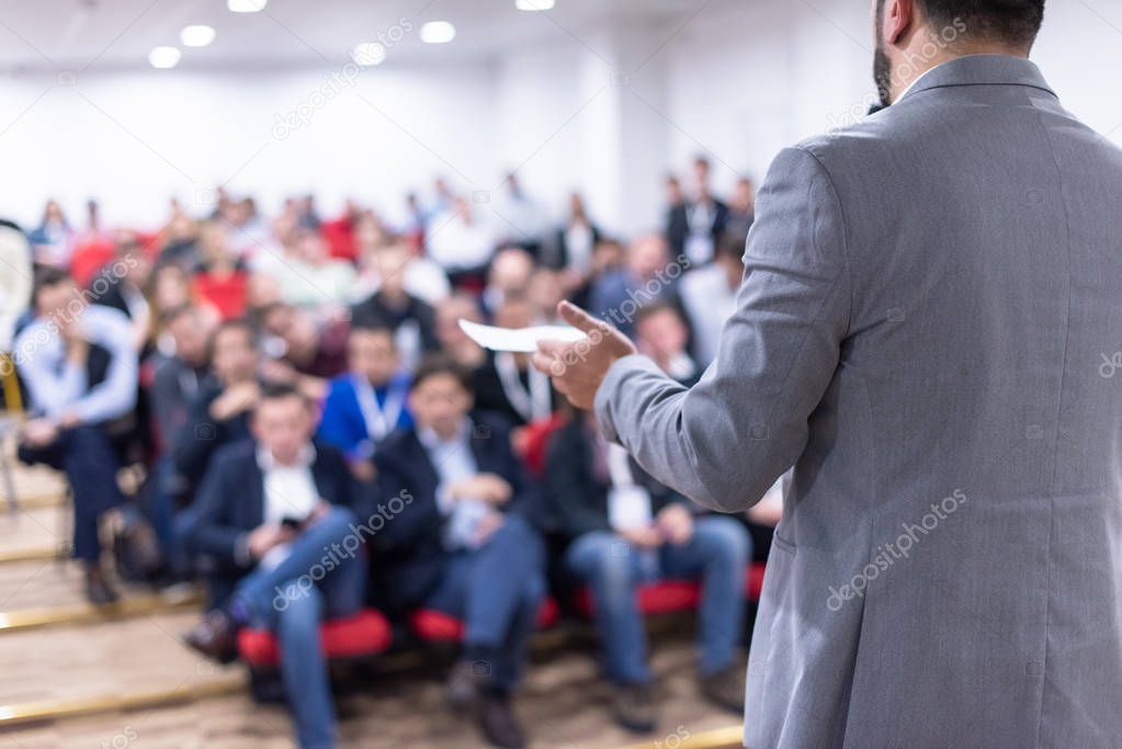 young businessman at business conference room with public giving presentations. Audience at the conference hall. Entrepreneurship club