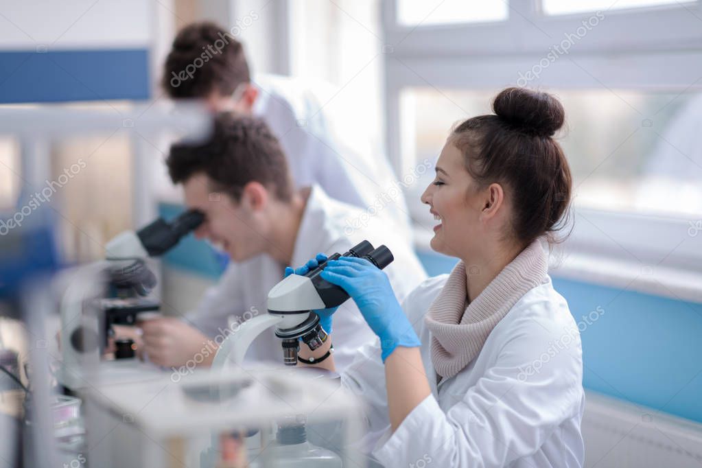 Group of young medical students doing research together in chemistry laboratory,teamwork by college student indoors