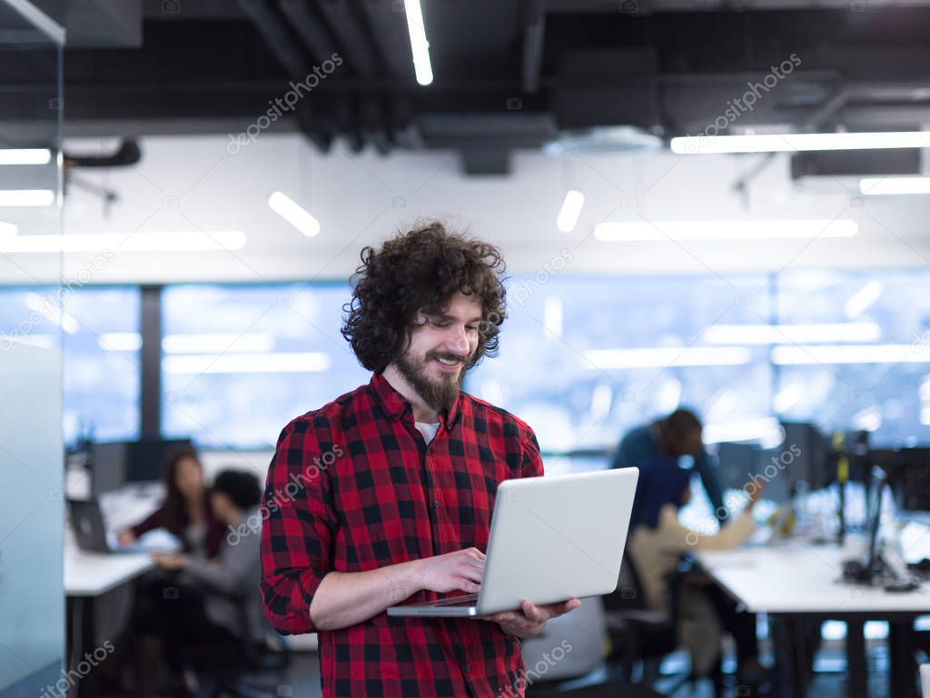 smiling male software developer using laptop