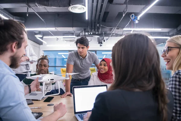 multiethnic business team learning about drone technology