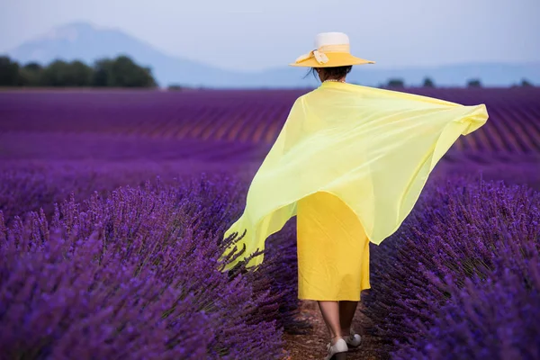 Aziatische vrouw in gele jurk en hoed op lavendel veld — Stockfoto