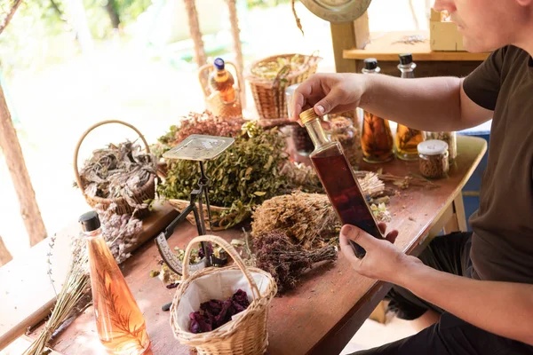 Trinkflasche in der Hand eines Kräuterkundigen — Stockfoto