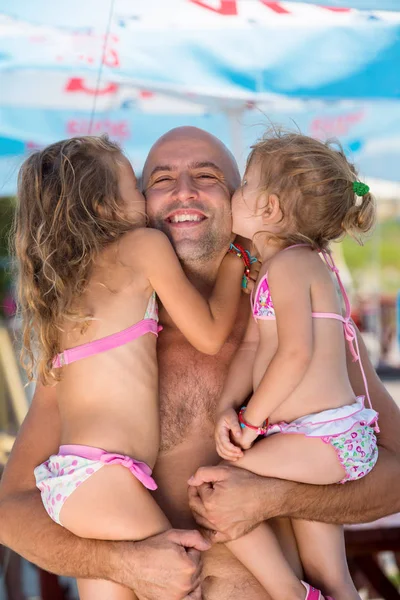 Portrait of young happy father with daughters by the sea — Stock Photo, Image