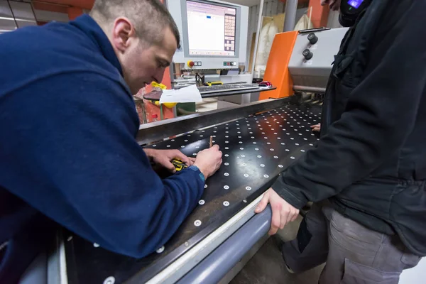 Carpenters calculating and programming a cnc wood working machin — Stock Photo, Image