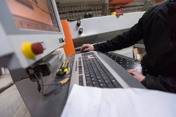 Carpenters calculating and programming a cnc wood working machin — Stock Photo, Image