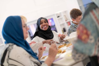 black modern muslim woman enjoying iftar dinner with family clipart