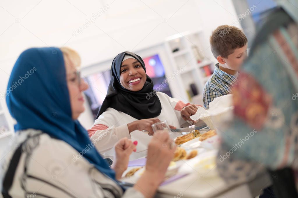 black modern muslim woman enjoying iftar dinner with family