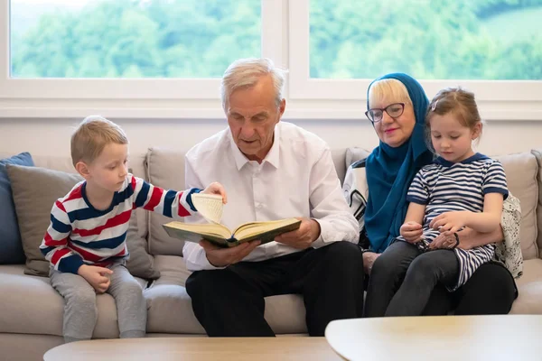 Moderne muslimische Großeltern mit Enkeln, die quran lesen — Stockfoto