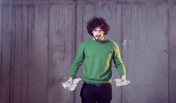 Business man displaying a spread of american dollar cash money — Stock Photo, Image