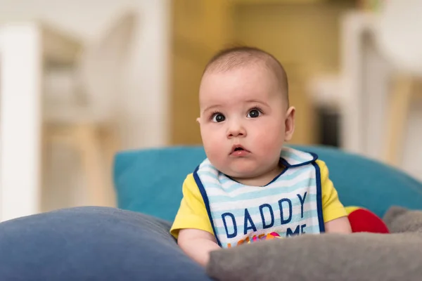 Bambino seduto tra i cuscini sul divano — Foto Stock