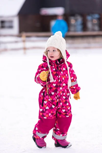 Little girl having fun at snowy winter day — Stock Photo, Image