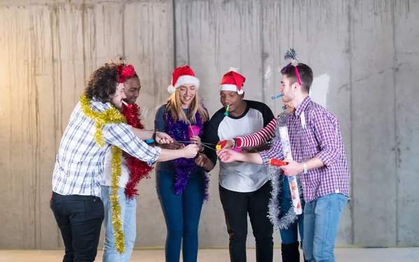 Multiethnic group of casual business people lighting a sparkler — Stock Photo, Image