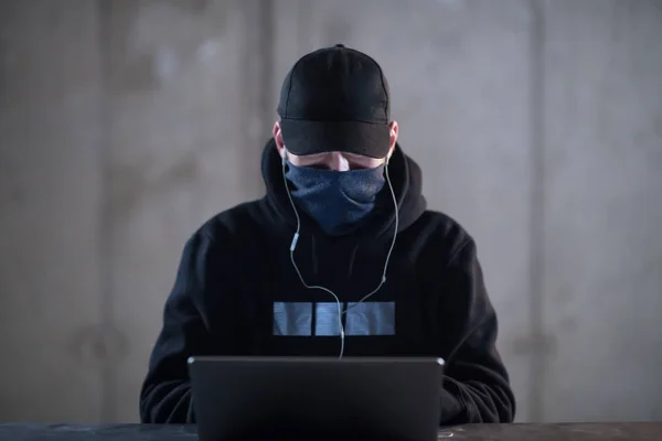 Talentoso hacker usando computador portátil enquanto trabalhava no escuro offi — Fotografia de Stock