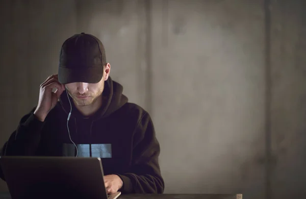 Talented hacker using laptop computer while working in dark offi — Stock Photo, Image