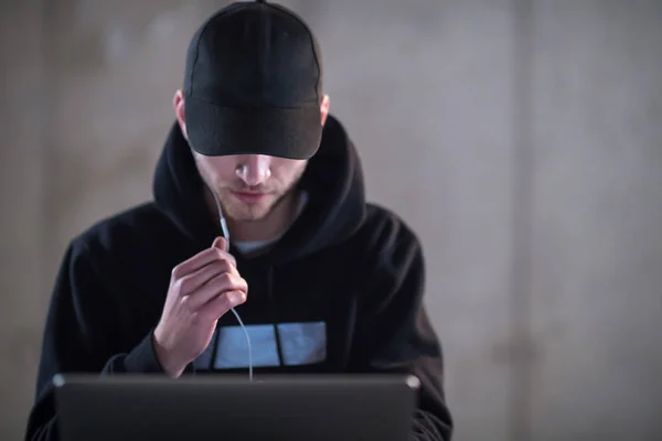 Talented hacker using laptop computer while working in dark offi — Stock Photo, Image