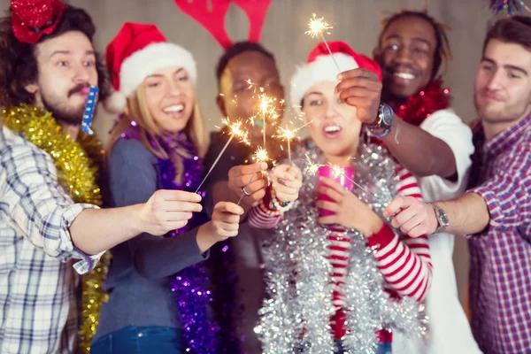 Grupo multiétnico de pessoas de negócios casuais iluminando um sparkler — Fotografia de Stock