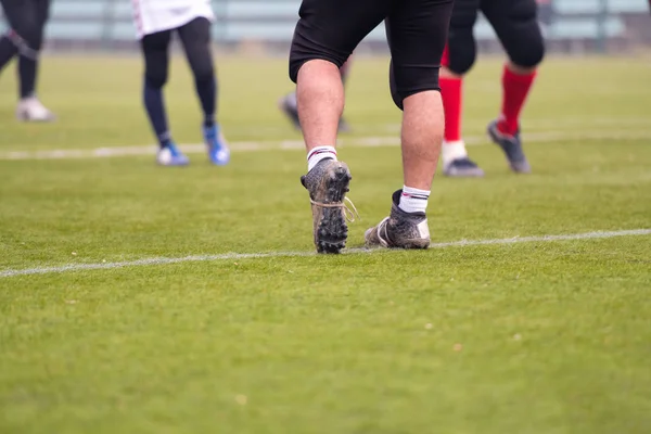 Close up of american football players stretching and warming up — Stock Photo, Image