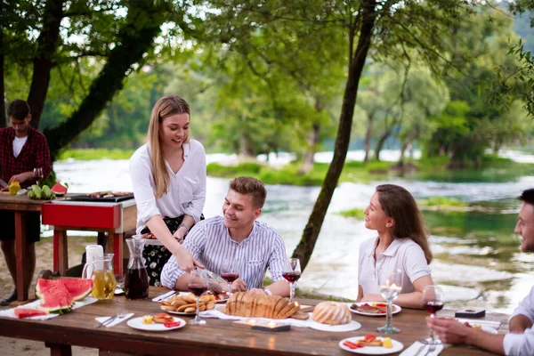 Glückliche Freunde mit Picknick Französisch Dinner Party im Freien — Stockfoto