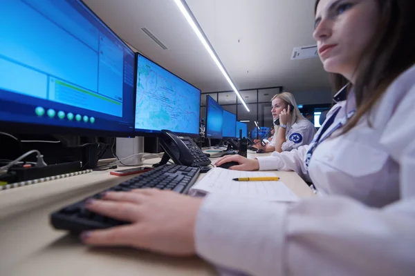 group of female security operators working in a data system control room  Technical Operators Working at  workstation with multiple displays, security guards working on multiple monitors in surveillance room, monitoring cctv and discussing