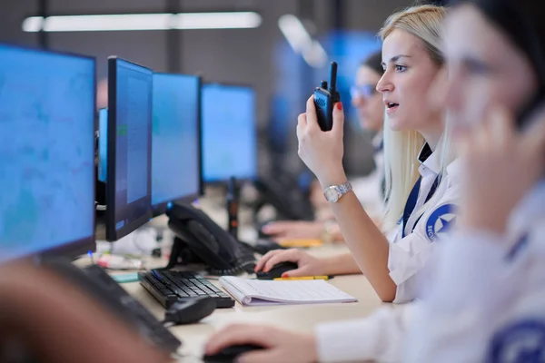 Female security operator working in a data system control room offices Technical Operator Working at  workstation with multiple displays, security guard working on multiple monitors