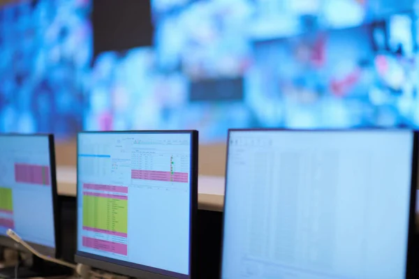 Empty interior of big modern security system control room, workstation with multiple displays, monitoring room with at security data center  Empty office, desk, and chairs at a main CCTV security data center