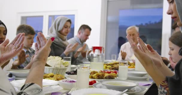 Famiglia musulmana che prega prima di cenare con iftar durante una festa del ramadan a casa — Video Stock