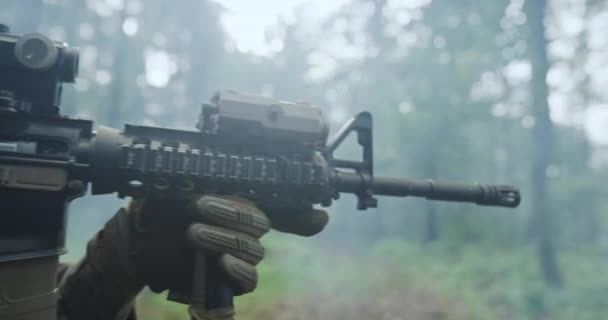 Soldat moderne avec fusil dans la forêt de tanières avec de la fumée dans backgorund — Video