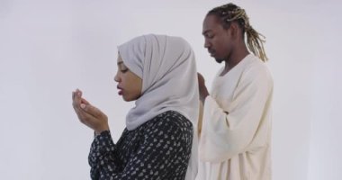 Afrikalı çift evde Kuran okuyor.