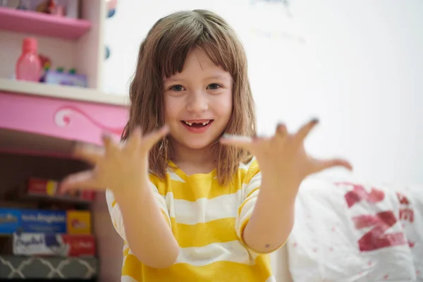 Schattig klein meisje thuis schilderen met handen — Stockfoto