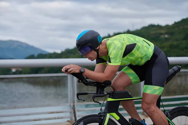 Triatlón atleta montar una bicicleta en el entrenamiento de la mañana —  Fotos de Stock