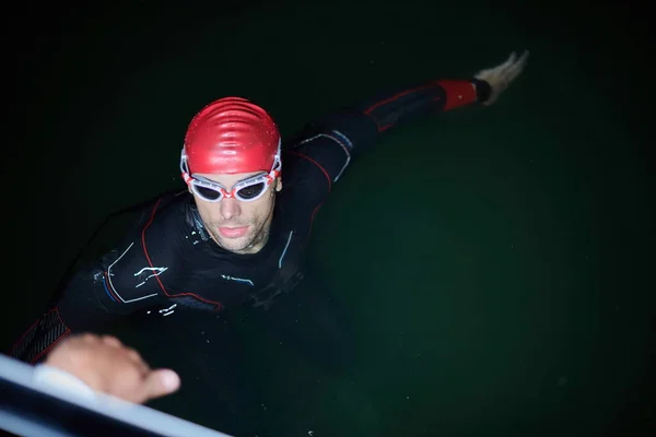 Auténtico nadador de triatleta teniendo un descanso durante el entrenamiento duro en la noche — Foto de Stock