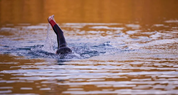 Αθλητής τριάθλου που κολυμπάει στη λίμνη την αυγή φορώντας στολή κατάδυσης — Φωτογραφία Αρχείου