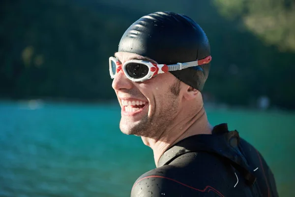 Triathlon athlete starting swimming training on lake — Stock Photo, Image