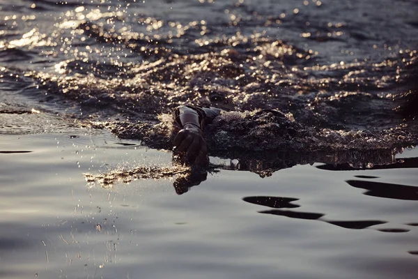 Triathlon athlete swimming on lake in sunrise wearing wetsuit — Stock Photo, Image