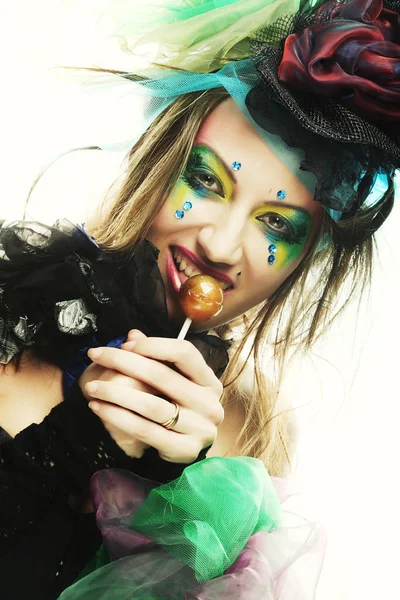 Girl with with creative make-up holds lollipop. — Stock Photo, Image