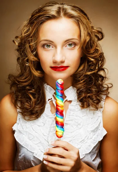 Curly  girl with a lollipop in her hand — Stock Photo, Image