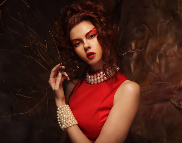 Sensual beautiful brunette woman posing in red dress. — Stock Photo, Image