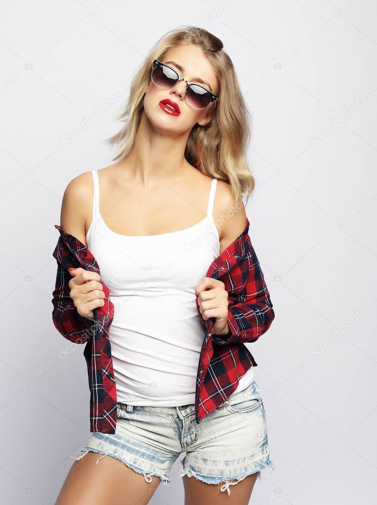 Young attractive woman in squared shirt and sunglasses