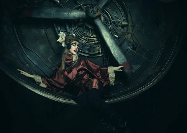 Aggressive stylish steampunk lady in a creative interior. Art an fashion concept. — Stock Photo, Image