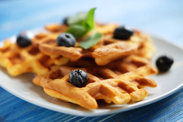 Homemade waffles with blueberries in plate on wooden table — Stock Photo, Image