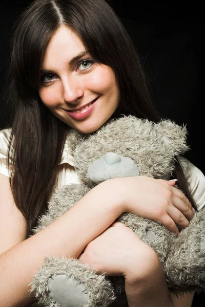 Woman holding a teddy bear — Stock Photo, Image
