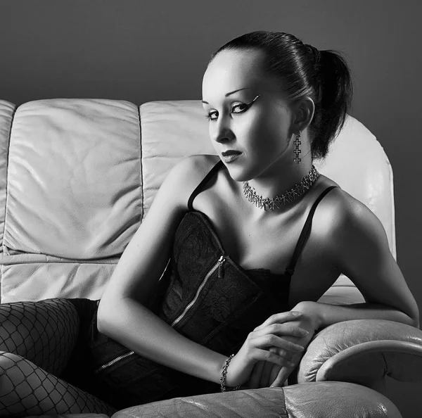 Portrait of sexy young model on sofa — Stock Photo, Image