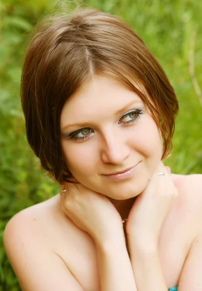 Young woman relaxing in the grass — Stock Photo, Image