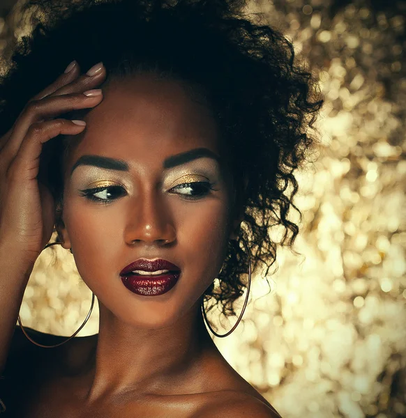 Impressionante Retrato de uma mulher negra afro-americana sobre fundo dourado — Fotografia de Stock