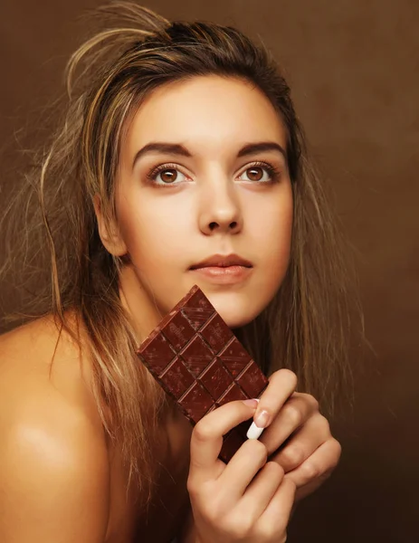 lifestyle, people and food concept: Beautiful girl with chocolate