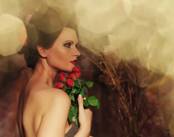 Piękna kobieta z czerwonymi różami. — Zdjęcie stockowe