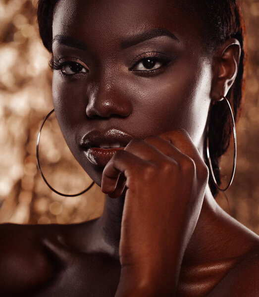 Portrait of beautiful african woman with creative gold make up