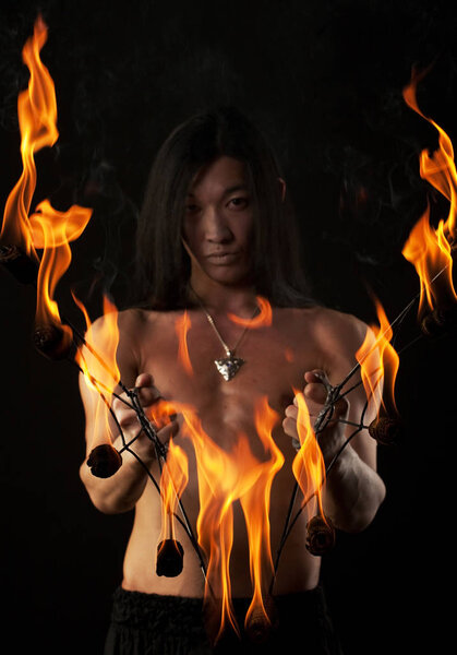 asian man with fire show