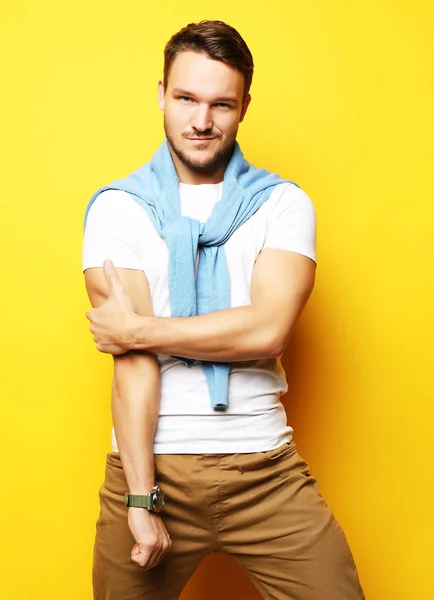 Picture of young handsome man standing isolated over yellow background. Looking at camera. — Stock Photo, Image