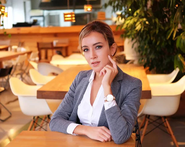 lifestyle, business and people concept: Successful business woman sitting In Coffee Shop.